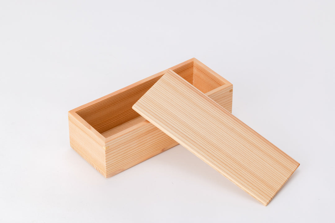 A rectangular box made of light-colored cedar sits on a white background with its lid open. The box is diagonal to the viewer.